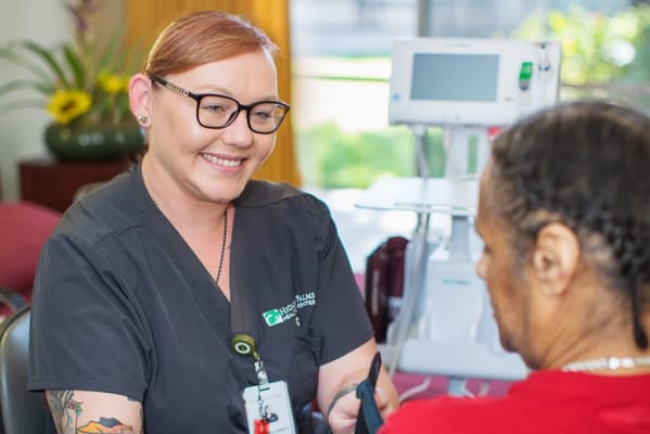 Care staff assisting a resident in a warm environment