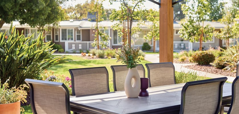 Outdoor dining area with view of resident buildings