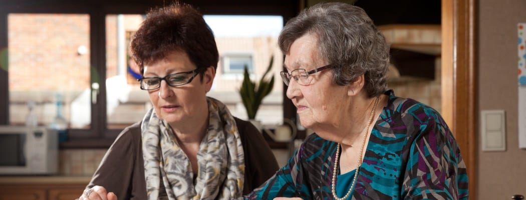 Two women engaging in a shared activity indoors