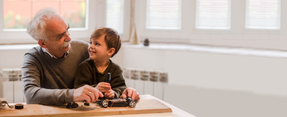 Senior man and child enjoy time together indoors