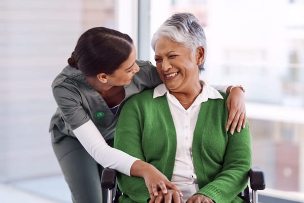 A caregiver and a resident sharing a joyful moment