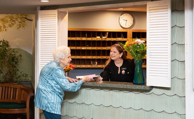 Staff assisting a resident at the reception area