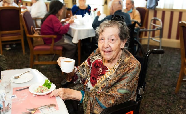 Resident enjoying a meal in the dining room