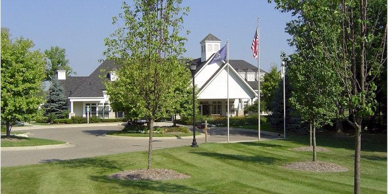 Exterior view of the facility with flags and landscaping
