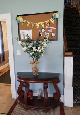 Welcoming interior decor with bulletin board and vase
