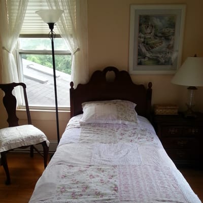 Cozy private room with a bed and sunlight