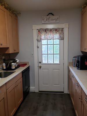 Bright kitchen area with a welcome sign