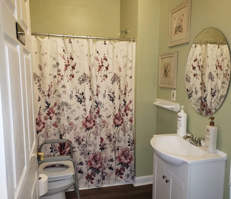 Private bathroom with floral shower curtain and sink