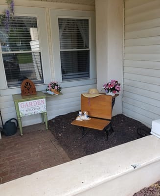 A cozy garden welcome area with flowers and decor