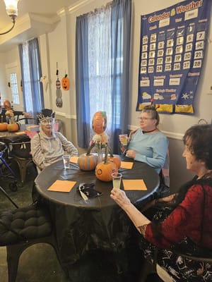 Residents enjoying a festive gathering with pumpkin decorations