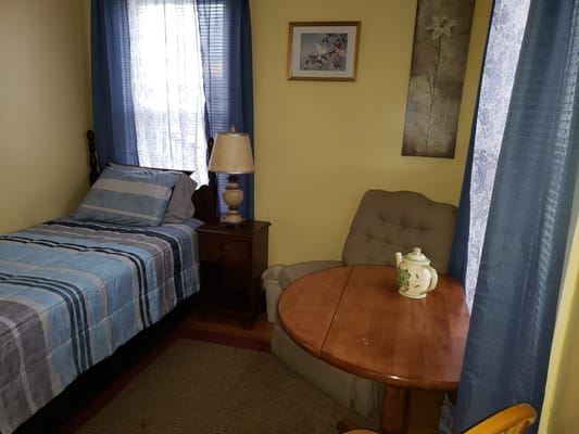 Cozy resident room with a bed and seating area