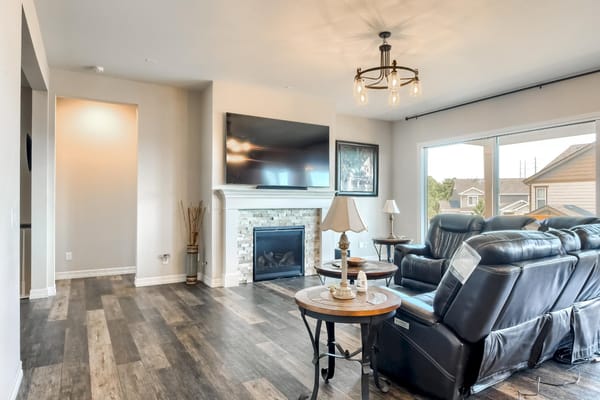 Bright common area with comfortable seating and a fireplace