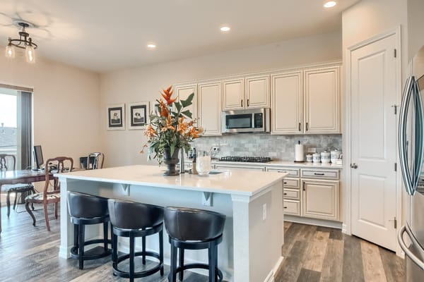 Modern kitchen area with flowers and seating