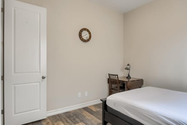 A simple, well-furnished resident room interior