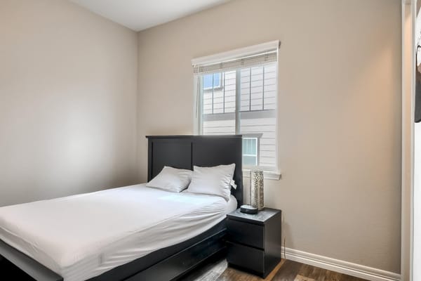 A private room with a bed and natural light