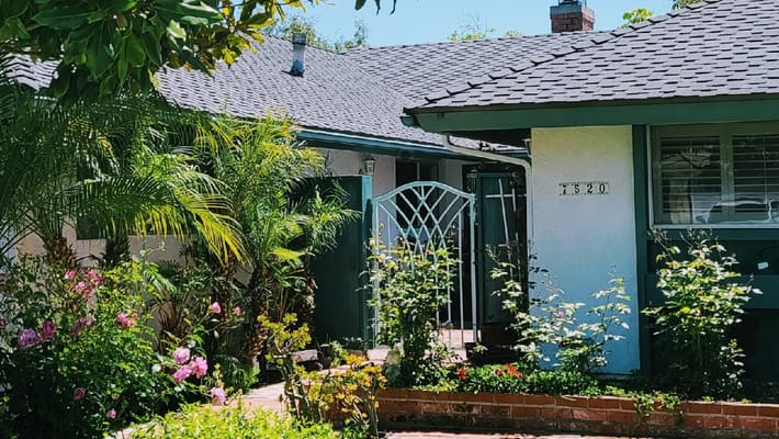 Entrance gate and flowers at Home Sweet Home Care facility
