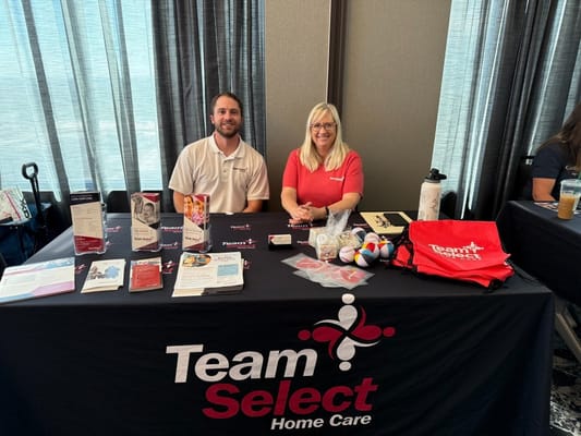Staff members at a table promoting home care services