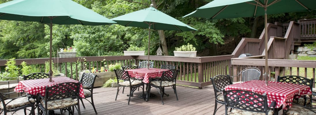 Outdoor patio area with dining tables and umbrellas