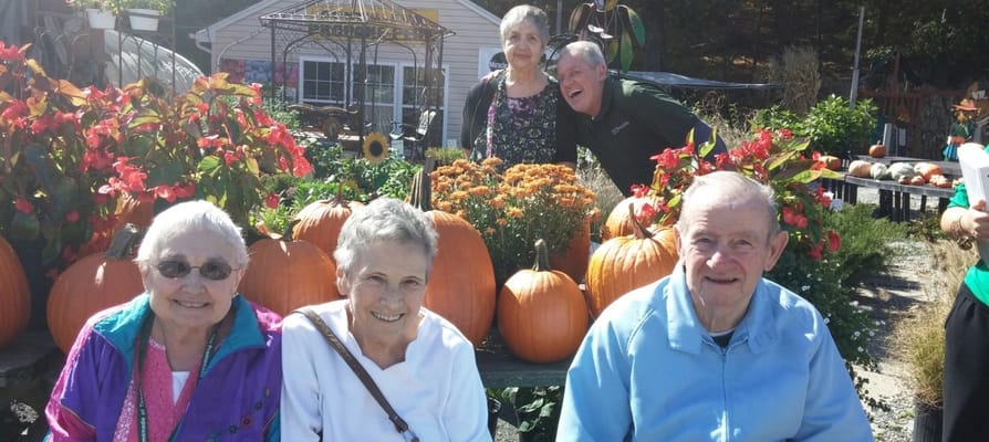 Residents enjoying time outdoors among pumpkins and flowers