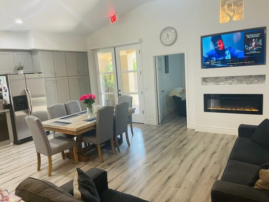 Stylish common area with a dining table and comfortable seating.