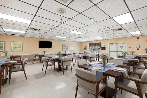 Bright dining room with tables set for meals