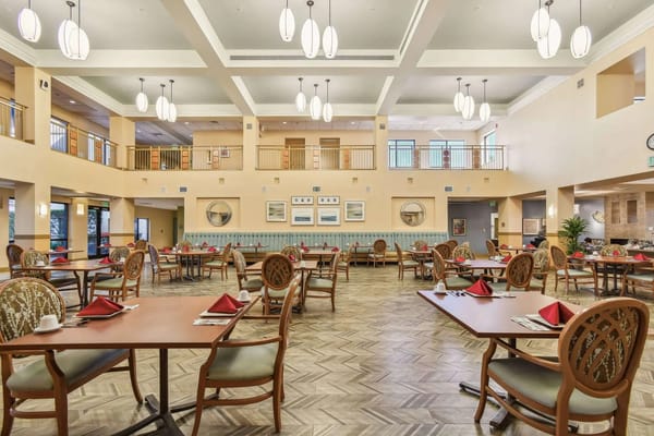 Dining area with neatly set tables and chairs