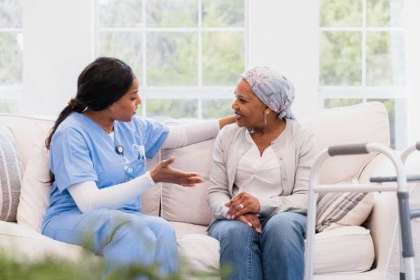 A caregiver chatting with a resident in a cozy living area