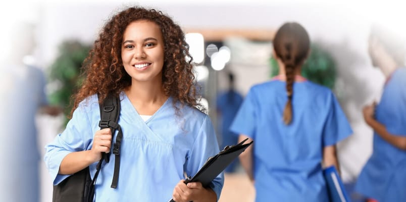Healthcare worker smiling in a facility hallway