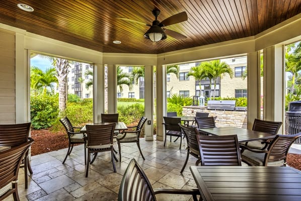 Outdoor seating area with tables and palm trees
