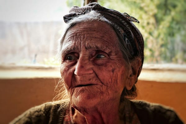 Close-up portrait of an elderly woman with a headscarf