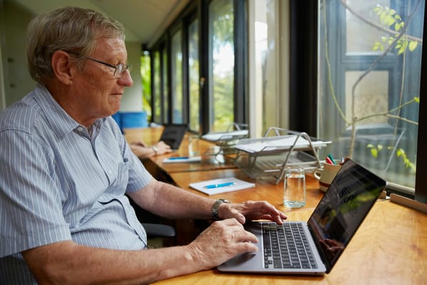 A resident working on a laptop in a communal space