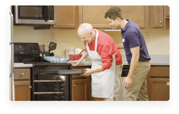 Staff assisting a resident in the kitchen
