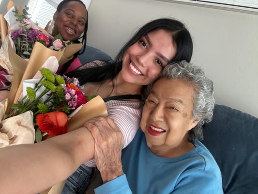 Residents and staff sharing smiles with flowers