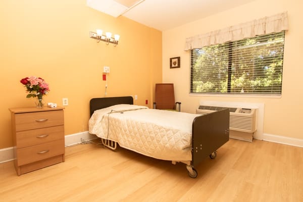 Private resident room with a bed and a window