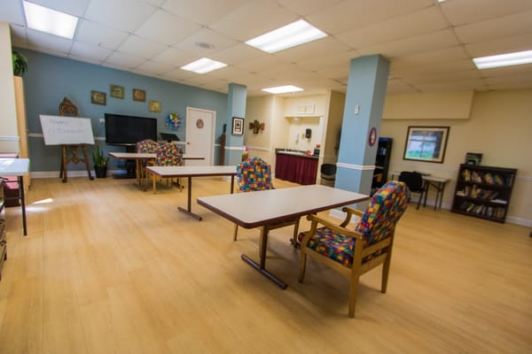 Bright activity room with tables and chairs