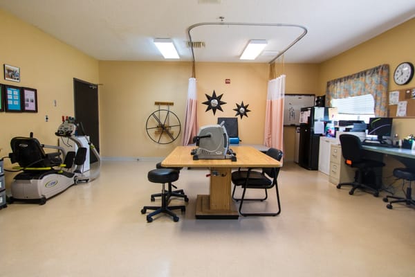 Occupational therapy room with equipment and workstations