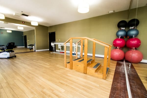 Interior view of a therapy room with exercise equipment