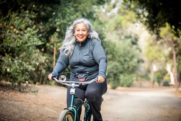 Senior woman riding a bicycle in a park