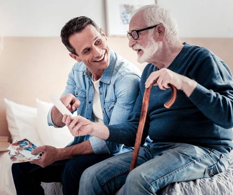 Resident and caregiver sharing moments with photographs