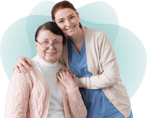 Caregiver posing with a resident in a facility setting