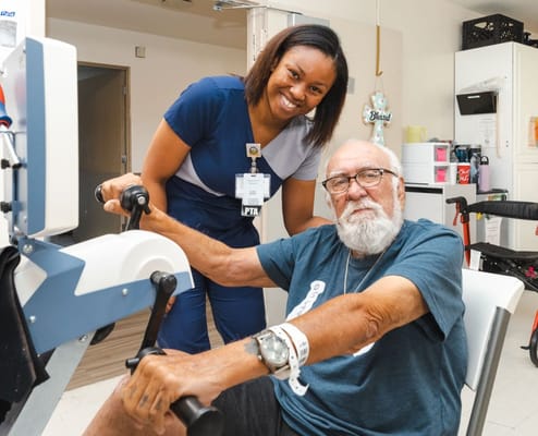 Staff assisting a resident in a therapy session