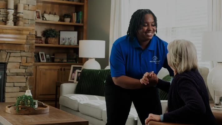 Staff assisting a resident in a common area