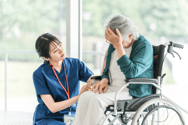 Caregiver assisting a resident in a wheelchair