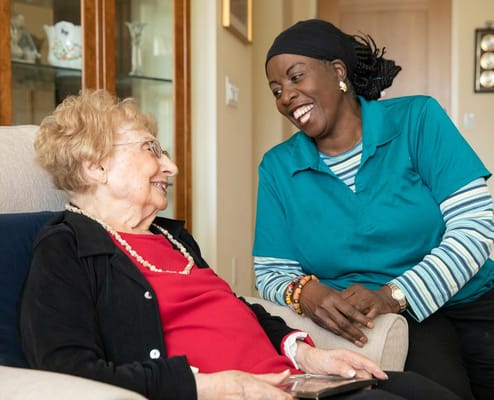 Caregiver interacting with a resident in a cozy setting
