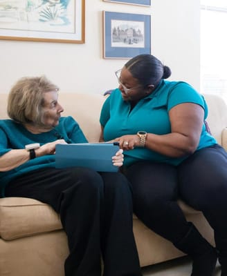 Staff member engaging with a resident on a couch