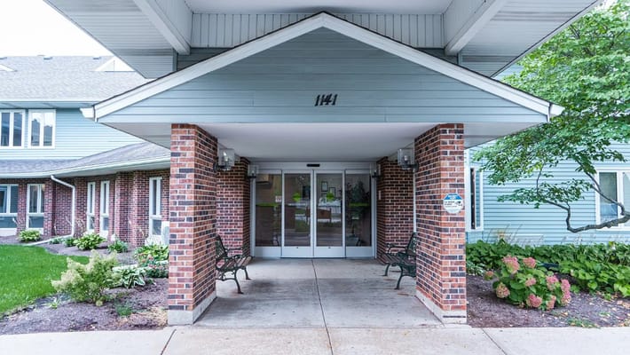 Entrance of a senior living facility with landscaping