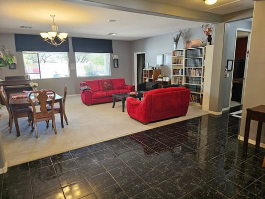 Interior common area with red couches and bookshelves