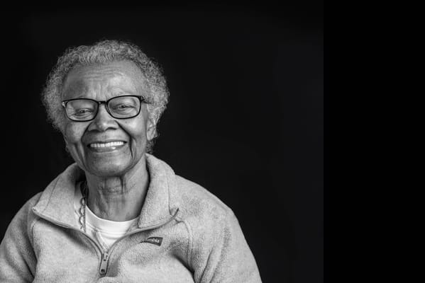 Smiling senior woman with glasses in a cozy setting