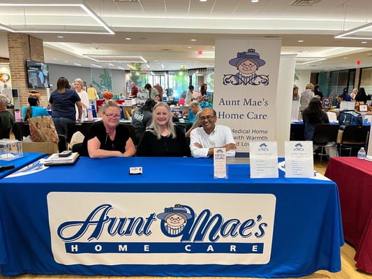 Three staff members at Aunt Mae's Home Care event