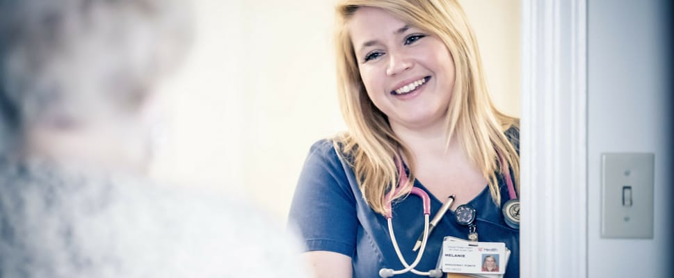 Healthcare staff interacting with a resident